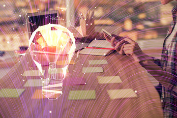 Double exposure of woman hands typing on computer and light bulb drawing. Idea concept.