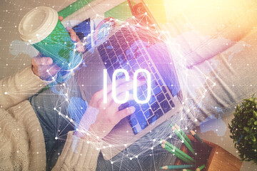 Double exposure of woman hands typing on computer and crypto market theme hologram drawing....