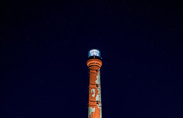 old lighthouse on the background of the starry sky