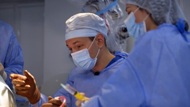 Surgery specialists operation treatment. Neurosurgeons workgroup in emergency ward.
