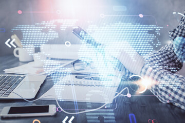 Multi exposure of man's hands holding and using a digital device and map drawing. International business concept.