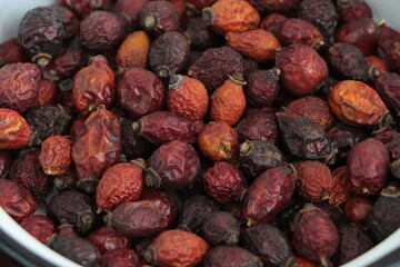 Top view dry rosehips in  bowl. Heap oof dog rose. Hip of the dogrose.
