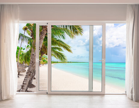 Fototapeta large glass door overlooking the beach