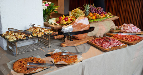 Colored buffet with seasonal fresh fruits and different kind of Ham