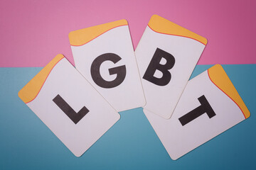 LGBT letters on pink and blue background. Love, pride and equality concept.
