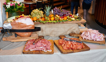 Colored buffet with seasonal fresh fruits and different kind of Ham