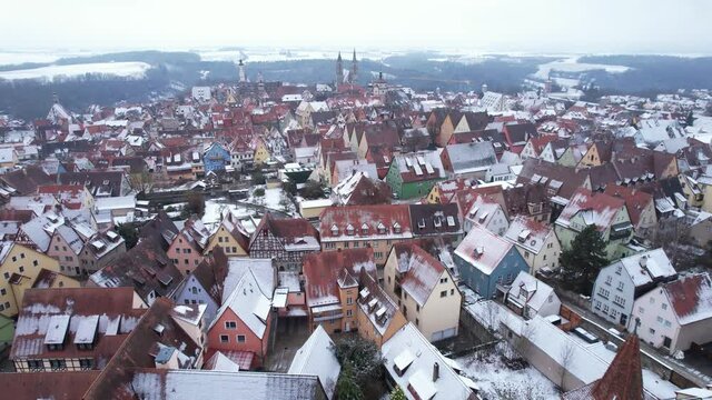 DRONE AERIAL FOOTAGE: Rooftops with snow in Rothenburg ob der Tauber, Bavaria. Rothenburg is one of the famous tourist attractions in Germany. It&rsquo;s well known for its well-preserved medieval old town.