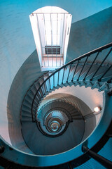 Fototapeta premium Looking down circular staircase inside historic lighthouse