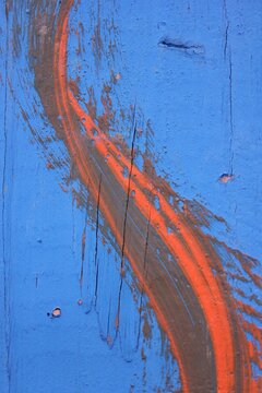 Orange Paint Swirl On Blue Background