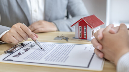 Fototapeta premium Contract signing, Home broker or salesperson allows customers to sign a contract to purchase a home as a legitimate homeowner, Transfer of ownership, Buy a new house.