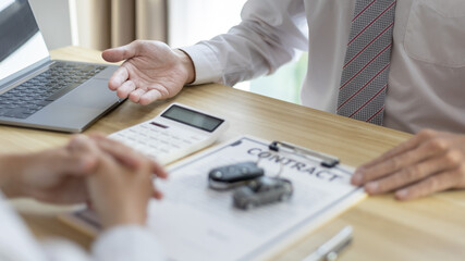 Selling cars, Car dealership or sales manager offers the sale of a car and explains the terms of signing a car purchase and insurance contract, Finance and after-sales service concept.