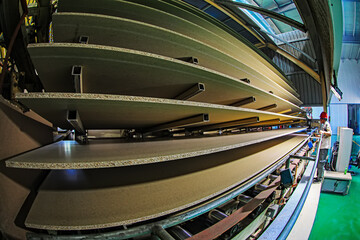 workers work intensively on the wood plate processing production line in the factory, China