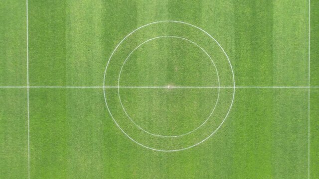 DRONE AERIAL FOOTAGE: The Manuela Machado Municipal Stadium, in Viana do Castelo, Portugal. Empty red running sports tartan track synthetic rubber on the athletic stadium.