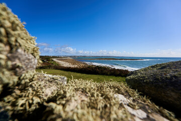 Wall gap on the Breton coast. Landscape with sea water against blue sky. Rocky background. France, Brittany, Audierne, Lervily.