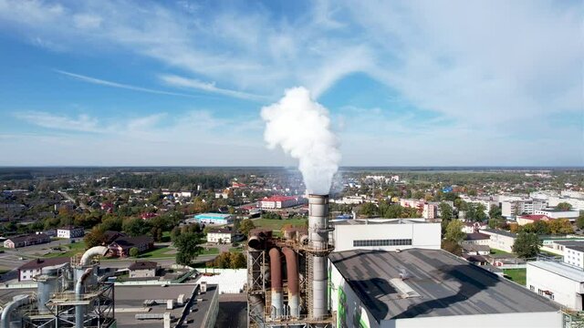 Smoke tower of industrial factory. Chimney smokestack emission.Refinery plant with pipes. Plant with smoke frow pipe and environmental pollution. Ecology concept and poor environment.
