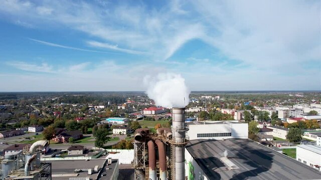 Smoke tower of industrial factory. Chimney smokestack emission.Refinery plant with pipes. Plant with smoke frow pipe and environmental pollution. Ecology concept and poor environment.
