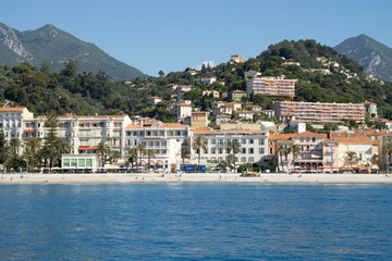 Fototapeta na wymiar Menton, view of the hotels and the promenade from the sea.
