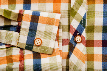 Fototapeta na wymiar Men's shirt. Button-down sleeve of a plaid shirt. Item of clothing
