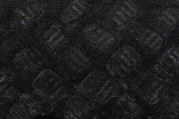 close-up of a black wooden panel background with geometric prints