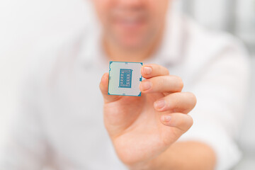 close up hand of repairman with processor. professional services.selective focus