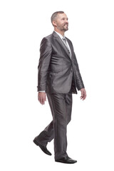 in full growth. confident business man striding forward.