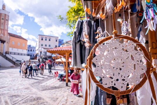 Chefchaouen, Morocco. October 10, 2021. Dream catcher hanging on stall for sale with pedestrian walking on street