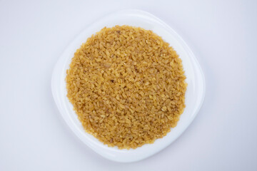 Bulgur on white plate close-up