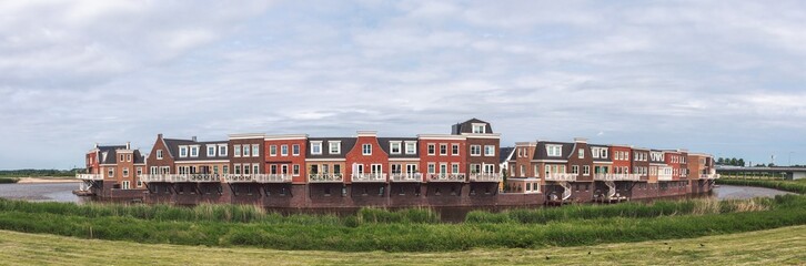 Modern residential area. Typical traditional dutch architecture style houses forming one district encircled by water. Gouda, Netherlands 