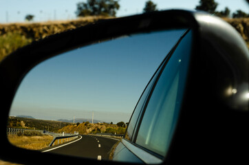 view in the car mirror on fast road in the Spain, beautiful landscape