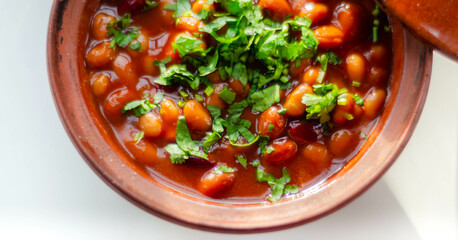 A hearty serving of baked beans in a ceramic dish, a healthy and nutritious meal