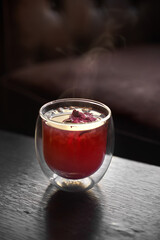 Hot tea in double glass cup, selective focus