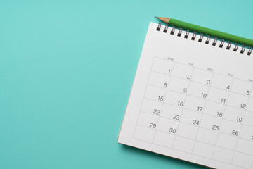 close up of calendar and pencil on the green table background, planning for business meeting or...