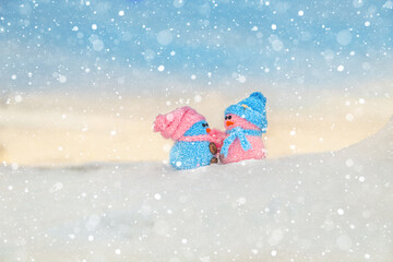 Cute homemade snowmen with scarves and hats on the mountain.