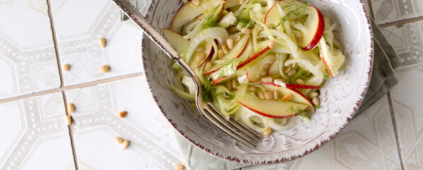 salad plate with apple, fennel and celery on the table - obrazy, fototapety, plakaty