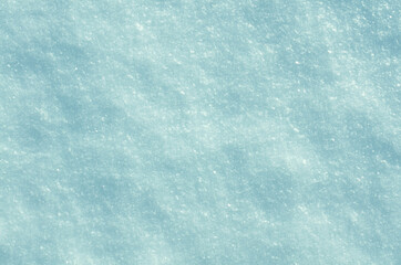 snow glistens in the sun in blue tinted