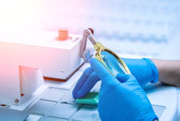 Laboratory assistant works at paraffin wax dispenser tissue embedding machine.