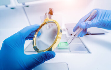 Laboratory assistant works at paraffin wax dispenser tissue embedding machine.
