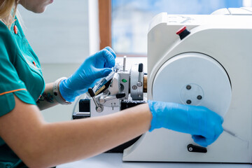Laboratory assistant works on a rotary microtome section and making microscope slides