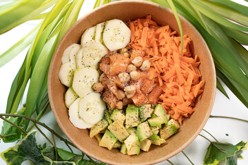 pokebowl with salmon, cucumber, avocado, carrots, chickpeas
