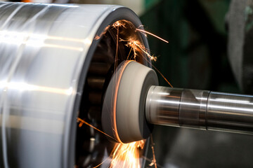 On the CNC machine, the inner cylindrical part is grinded from which sparks are spilled.