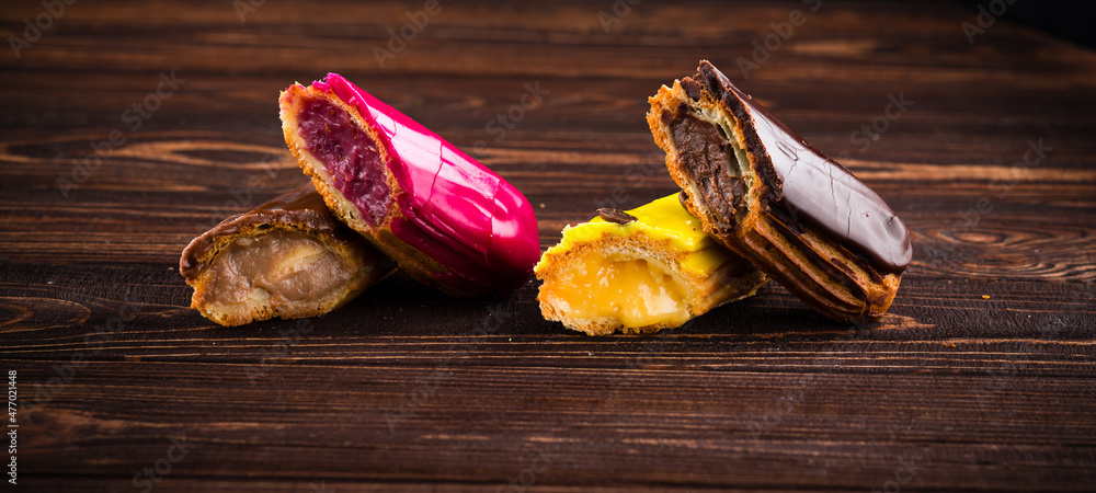 Poster multicolored glazed eclairs decorated. sweet dessert.