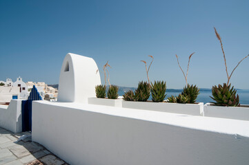 Obraz na płótnie Canvas A typical example of white architecture against the blue sky on the island of Santorini, Greece.
