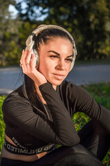 Cute sporty girl enjoying music with headphones
