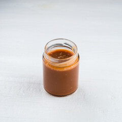 Homemade salted caramel in a glass jar. salted caramel in a jar