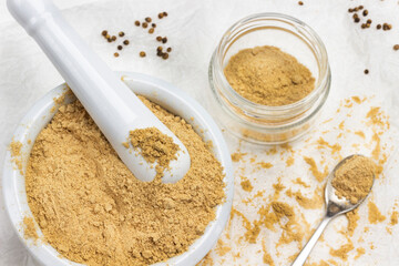Ground ginger in mortar and pestle.