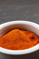 Dry ground paprika in ceramic mortar.