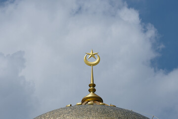 Close up picture of new golden spike, moon and star at the mosque dome during beautiful cloud insight.