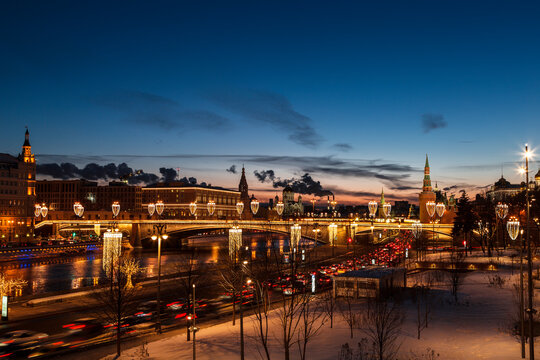 Evening winter Moscow at sunset. View of the Moskvoretskaya embankment, the Moskva River and the Bolshoy Moskvoretsky Bridge. Russia