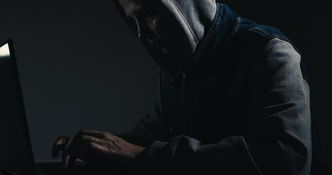 a professional female hacker uses a keyboard to enter incorrect data into an online computer system and spreads stolen personal information around the world.
