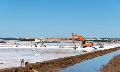 Excavator working in the production of salt